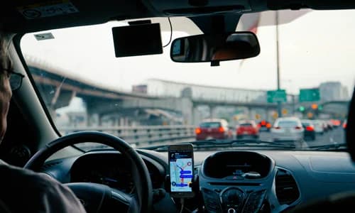 Dealership courtesy shuttle driver navigating to a customer pickup
