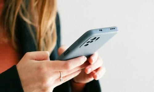 Woman using a mobile app to manage a dealership valet service