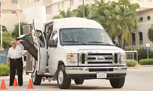 Healthcare shuttle van ready for safe patient transport outside a medical facility